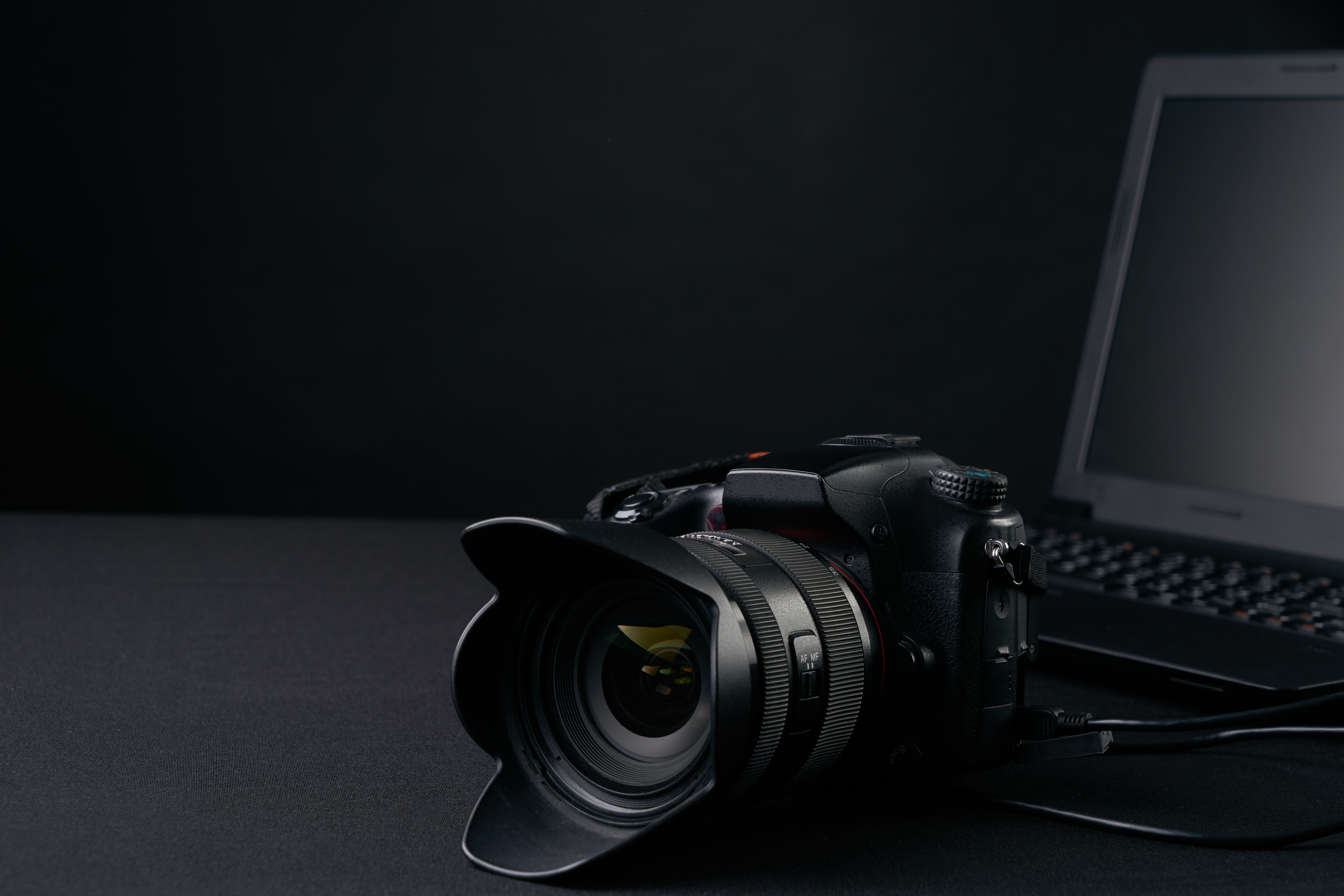 Closeup of professional  photography camera,modern laptop, home